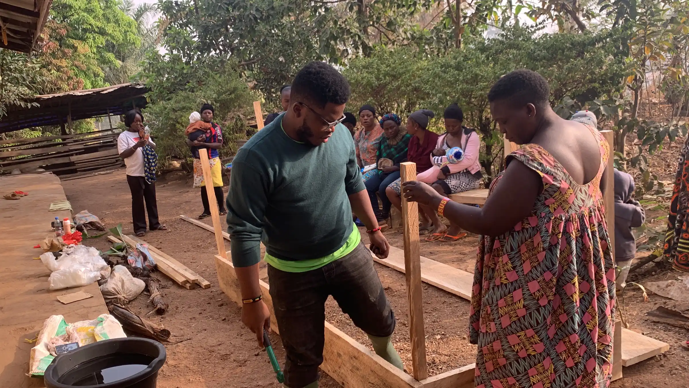 Farmers and Mumita field staff working together outdoors at a cooperative site