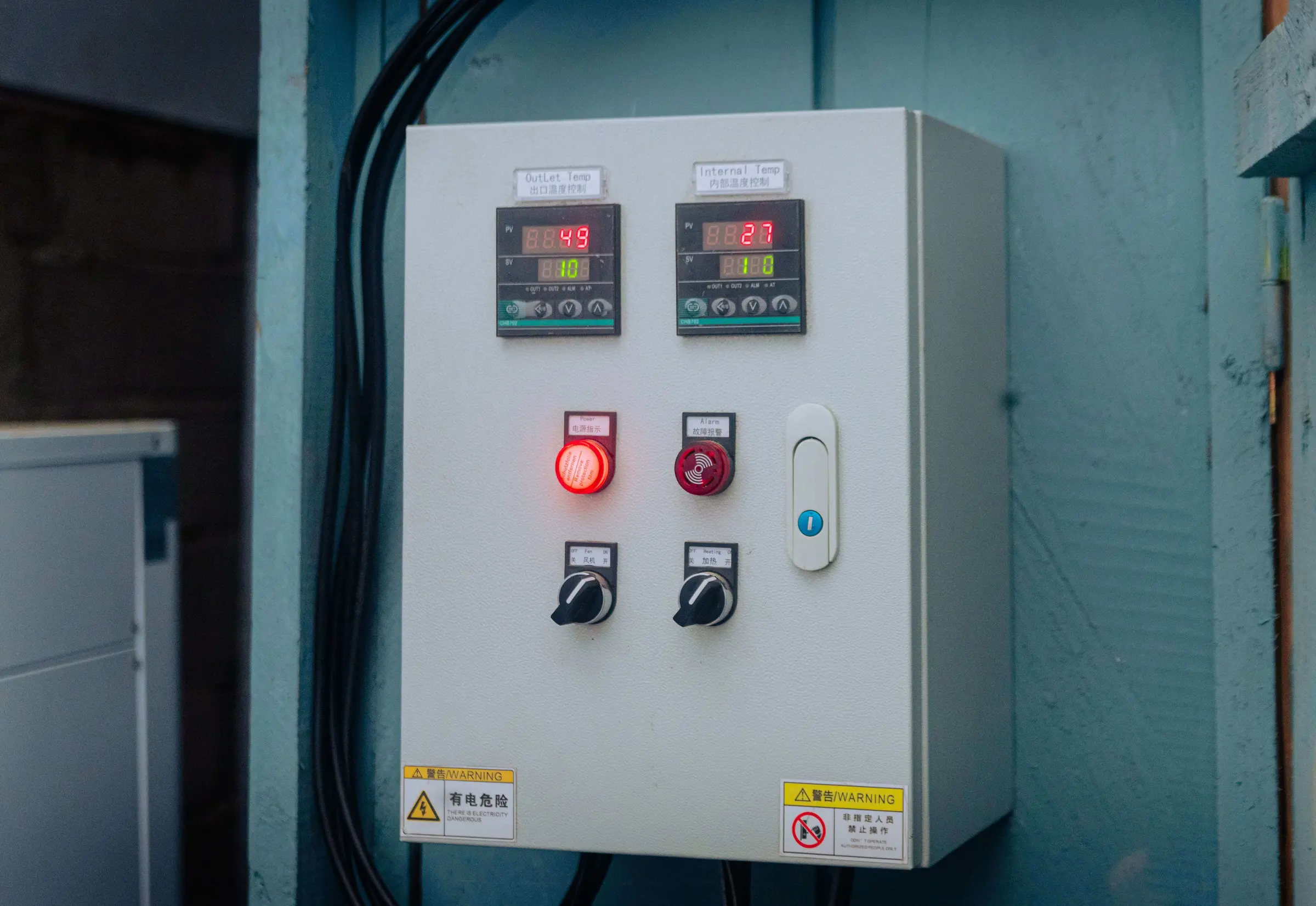 The control panel of a cold room, with temperature displays and switches