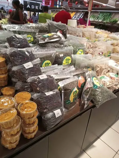 A mix of Mumita Foods packs of dried leaves and spices