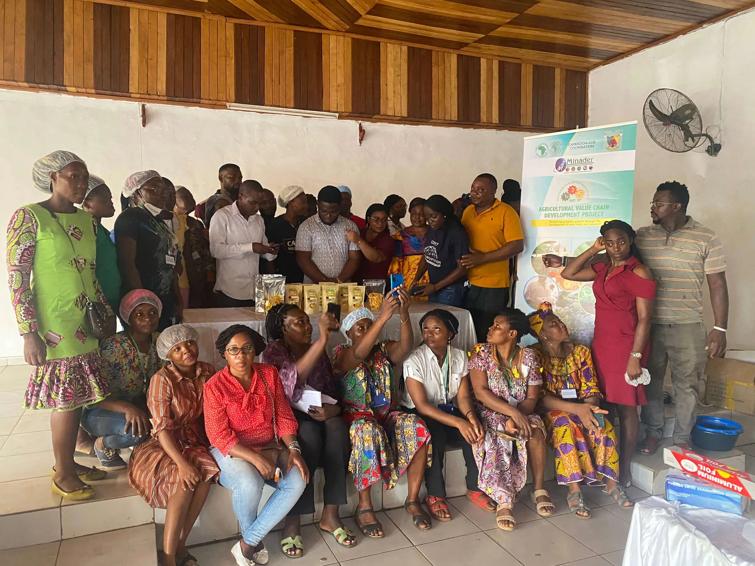 A large group of women and trainers gathered at the end of a training session