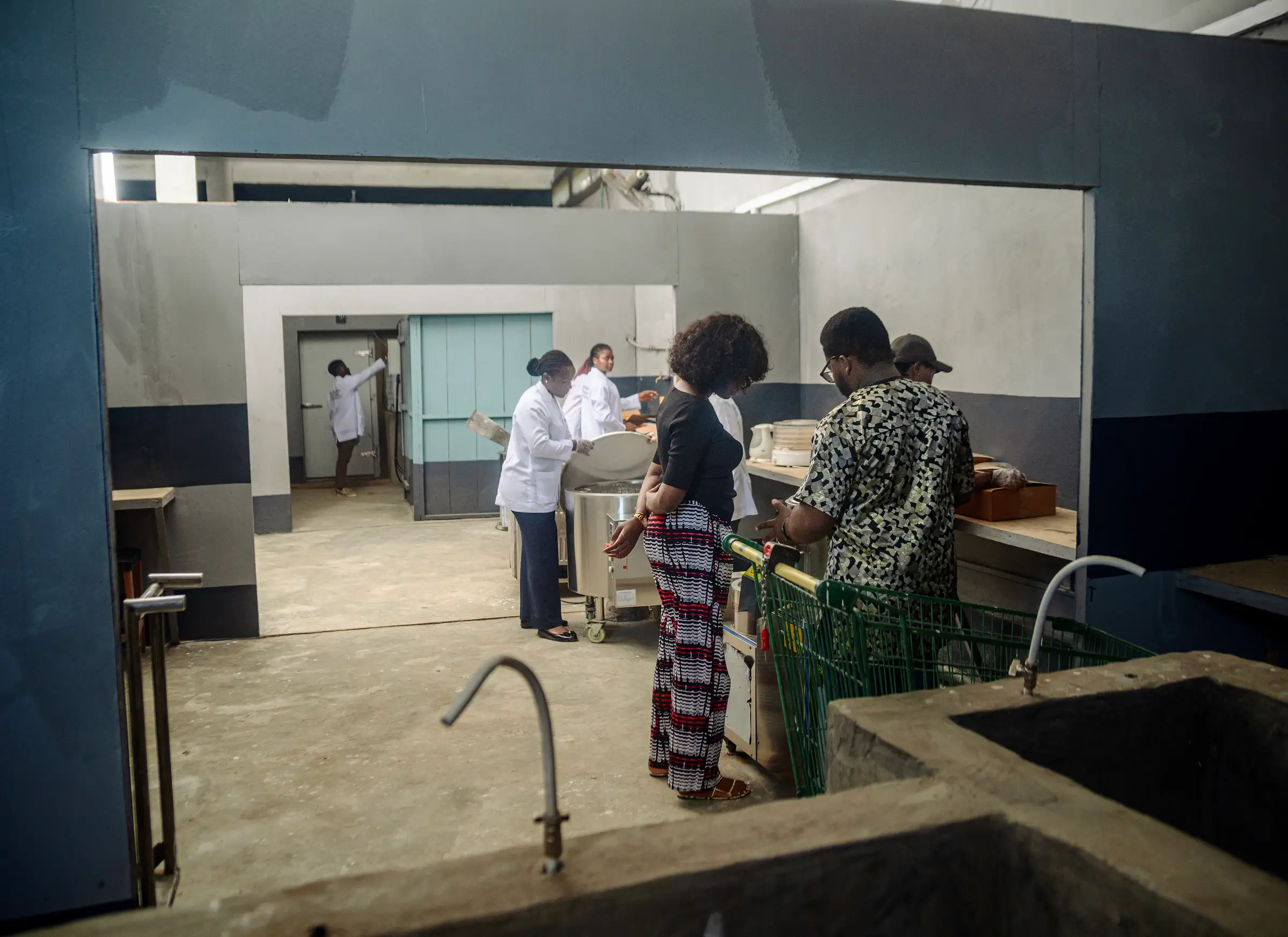 A view through the factory into the washing area, where staff work at stainless equipment