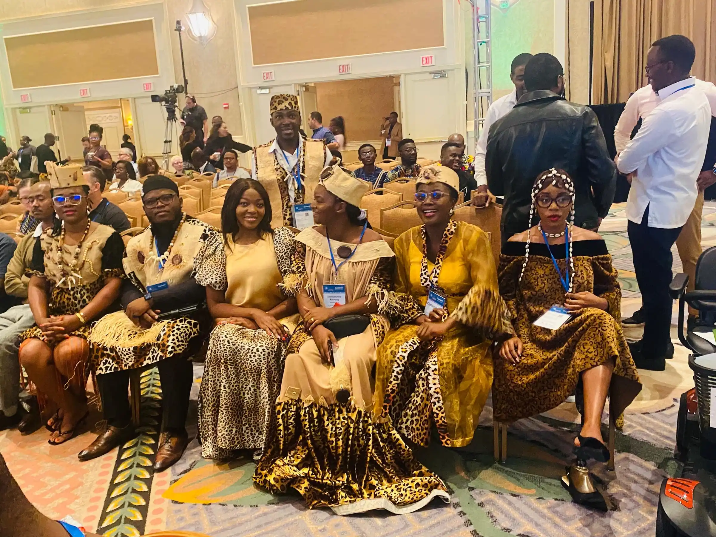 Delegates in traditional print outfits at a conference