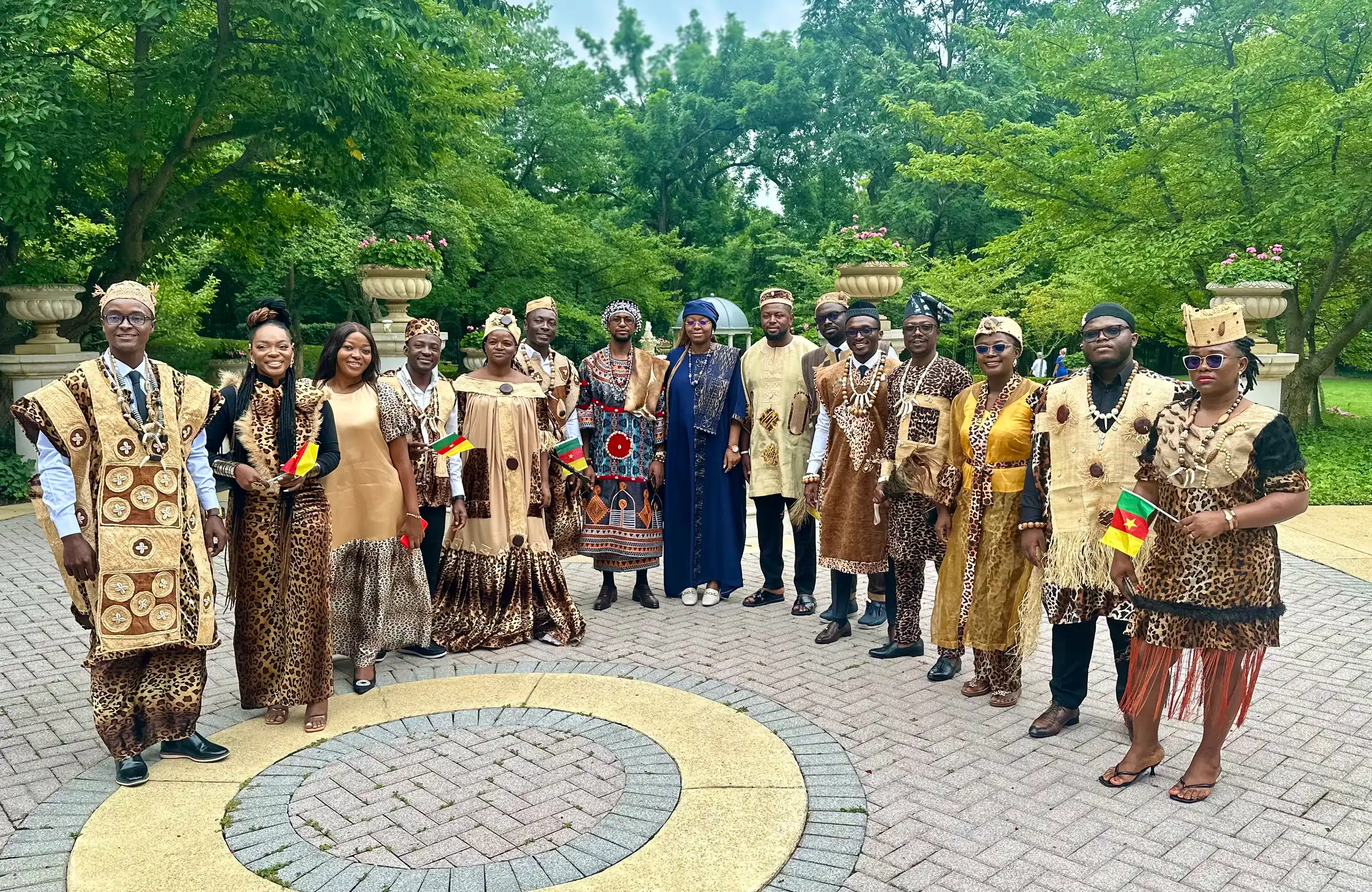 The Cameroonian delegation in traditional dress in a garden plaza