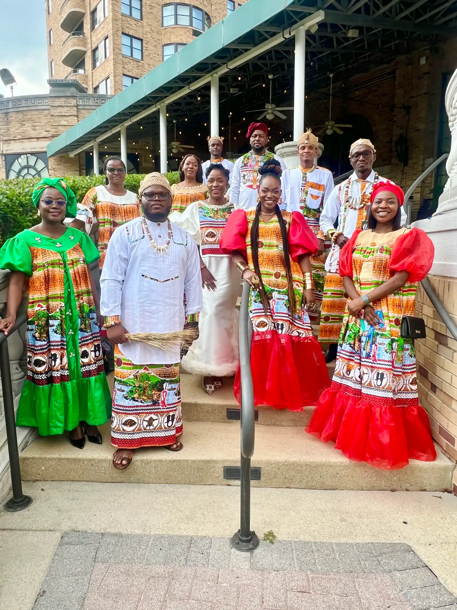 Delegates in matching Cameroonian print outfits on hotel steps