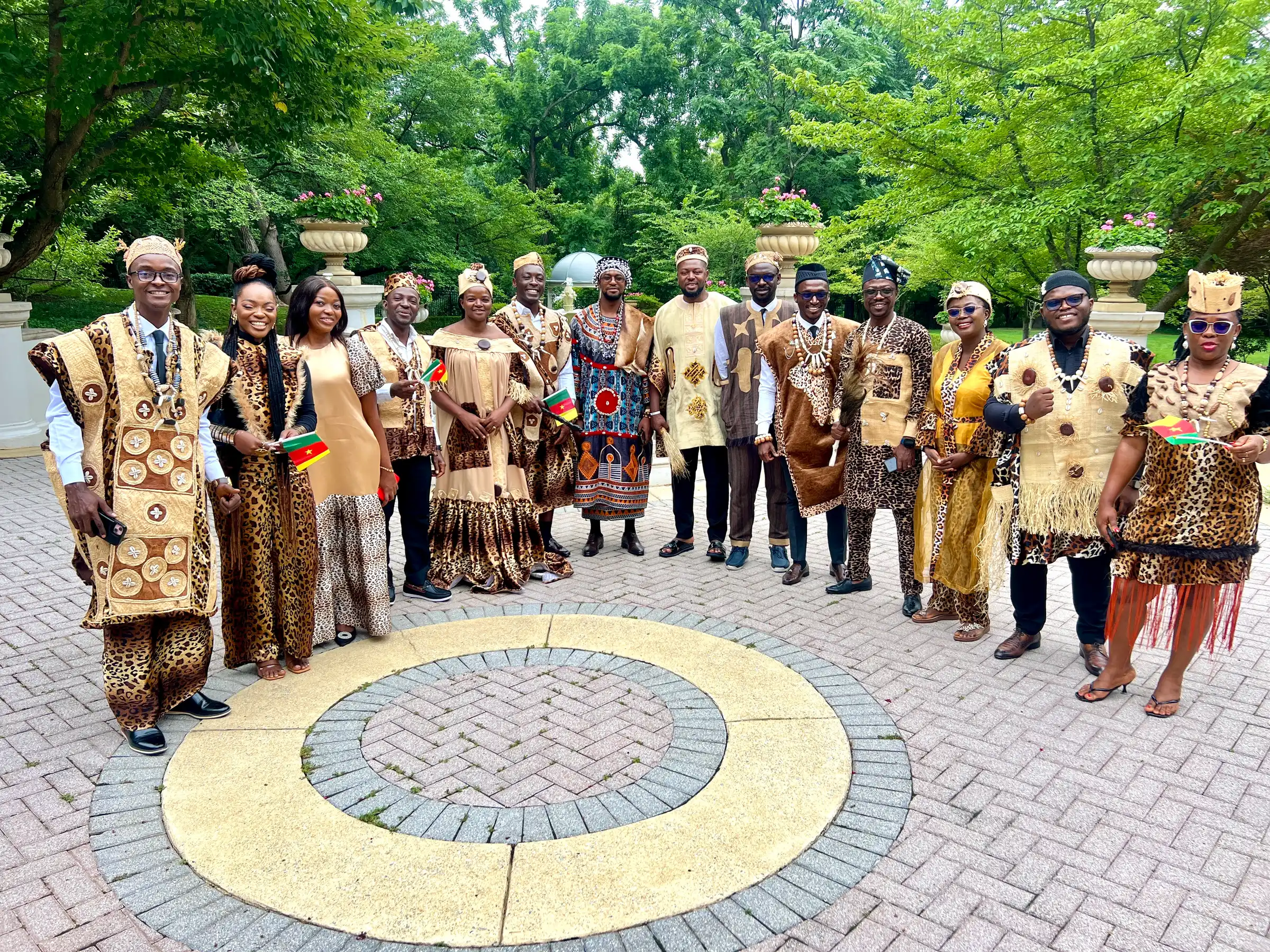 The delegation in traditional dress in a garden plaza