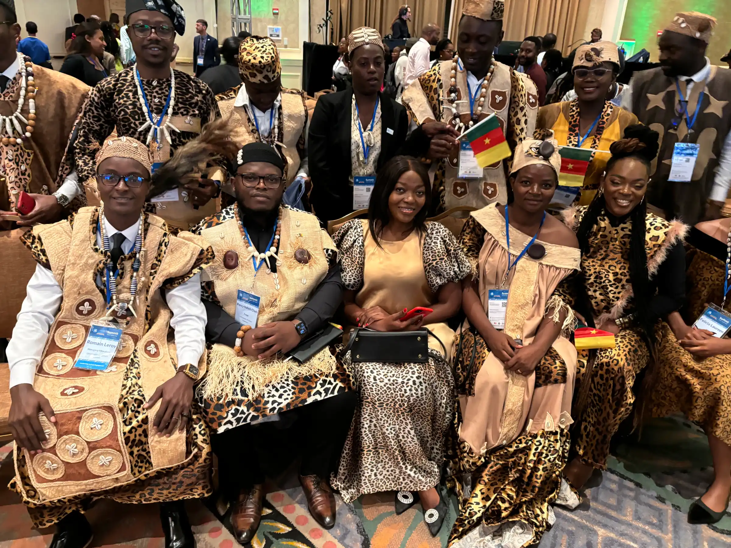 Delegates in traditional dress seated at a summit session